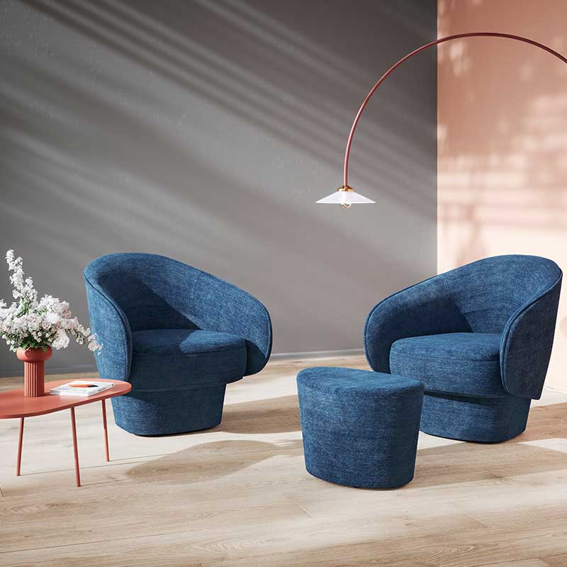 Zwei blaue Designer-Sessel, vor dem rechten steht ein passender Hocker. Wohnzimmer-Atmosphäre.
